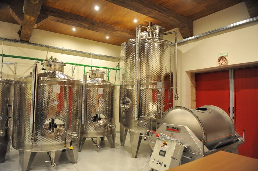 wine storage tanks and grape press machine at 'Piperis Winery' plant